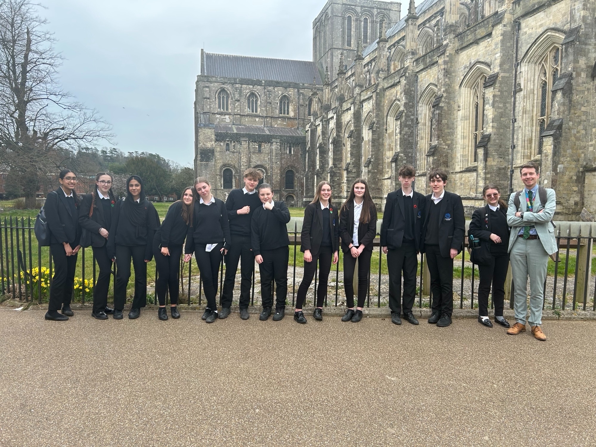Image shows the Year 10 pupils standing outside Winchester Cathedral with Mr Hughes