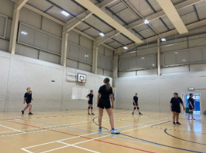 Image shows the Year 9 and 10 girls volleyball team playing a match