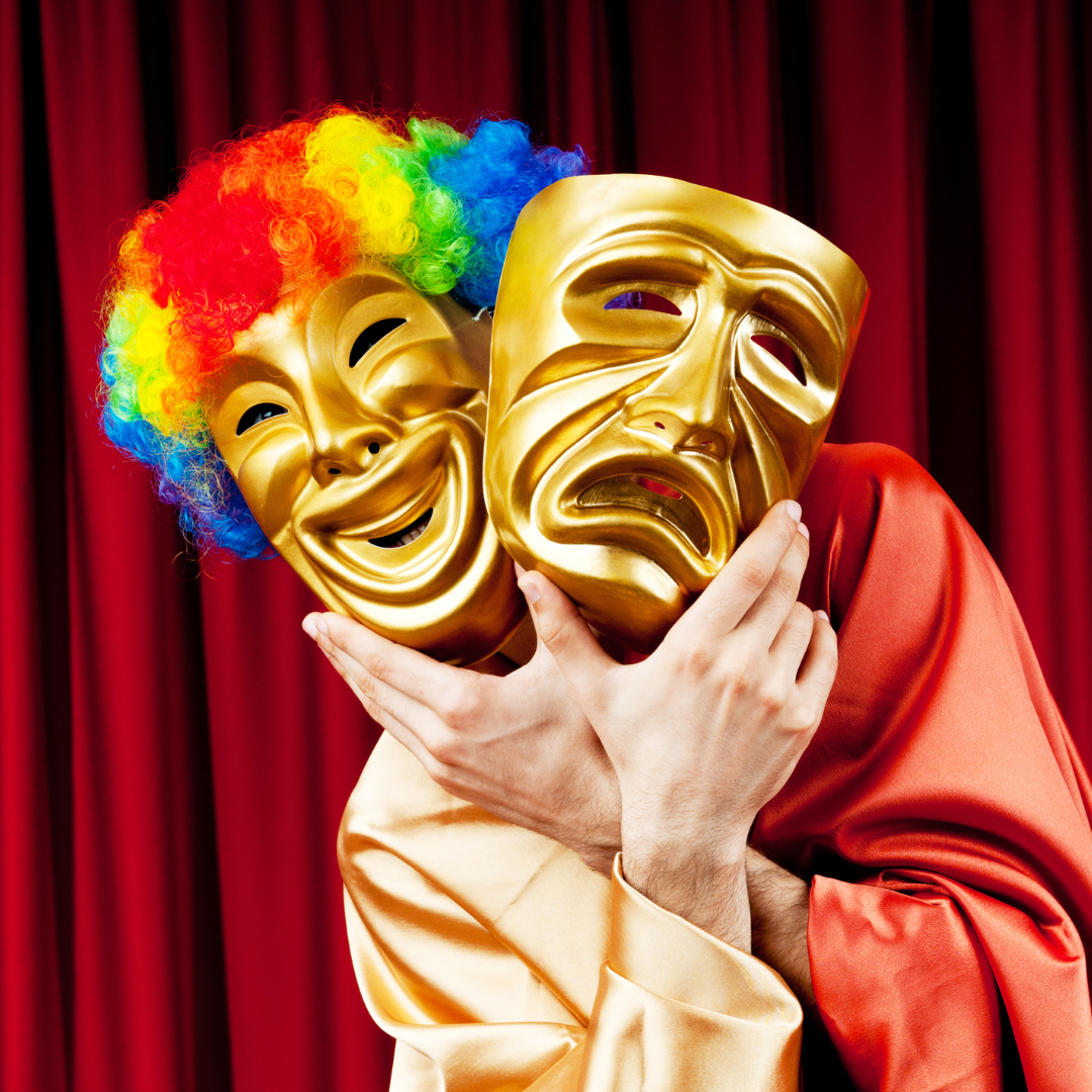 Image shows someone holding up a happy mask and a sad mask