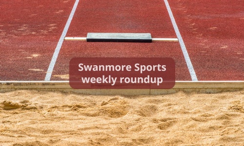 Image shows the end of a long jump runway, the take-off board and the edge of the sand pit.