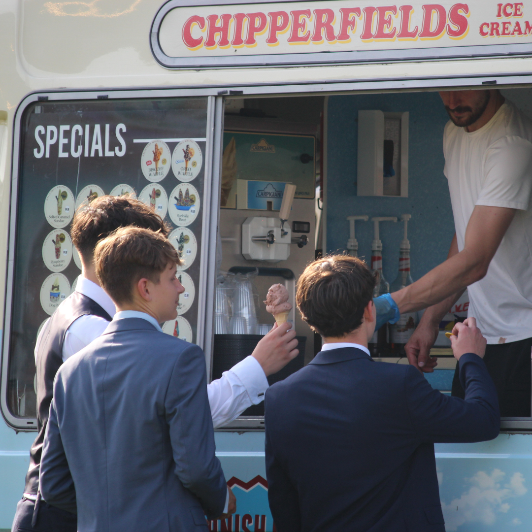Pupils collecting ice creams from an ice cream van.
