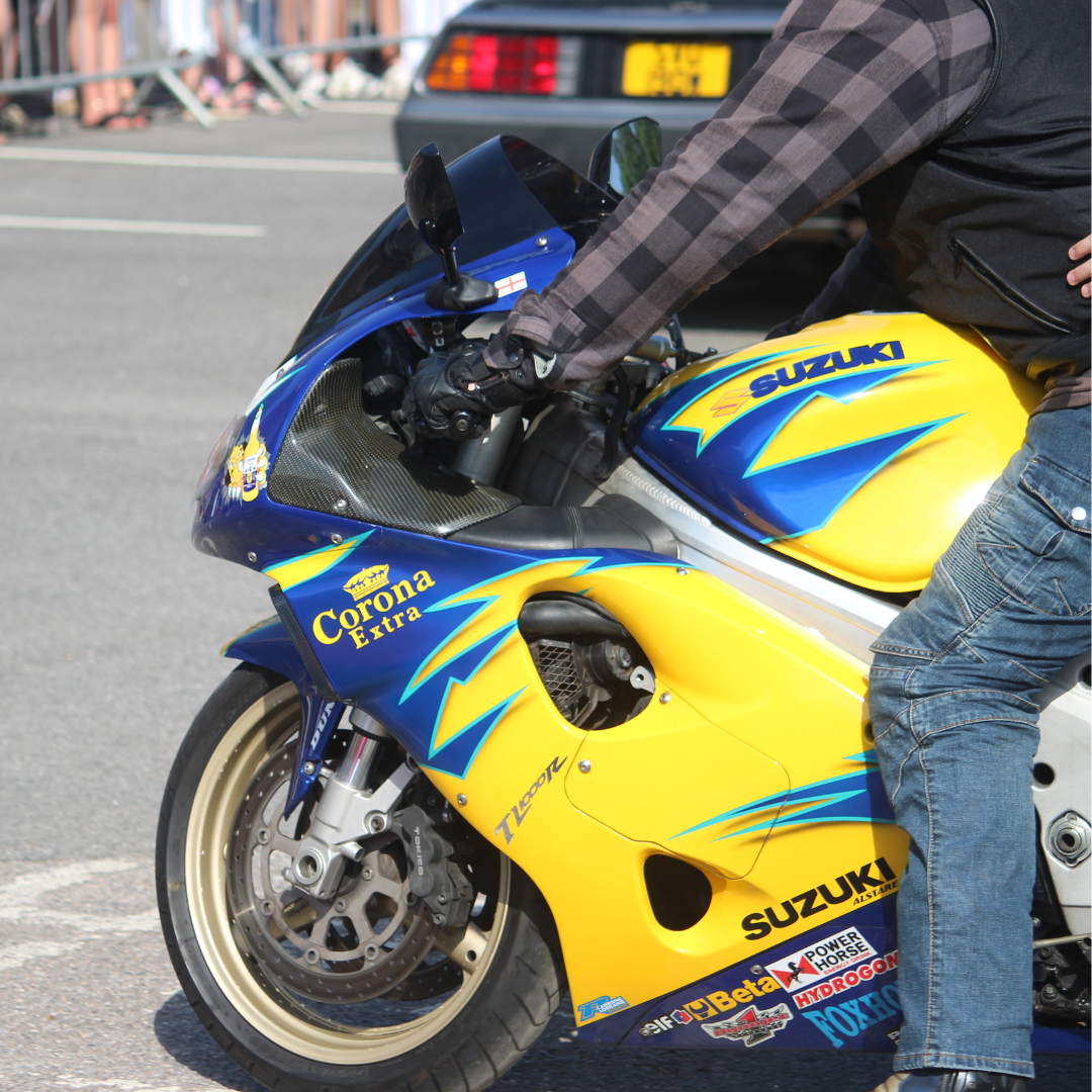 Close-up of a Suzuki sports motorcycle parked at the prom arrival area.