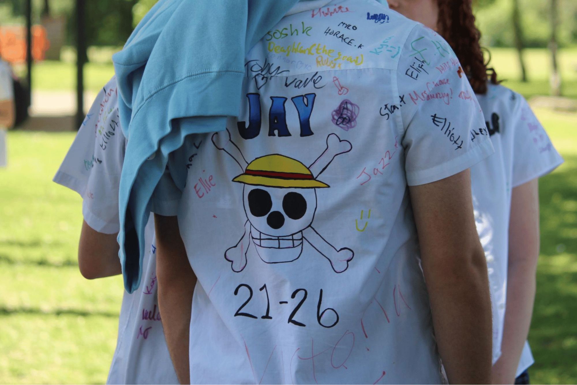 Back of a Year 11 pupil's shirt featuring a large One Piece-inspired design with signatures and messages.