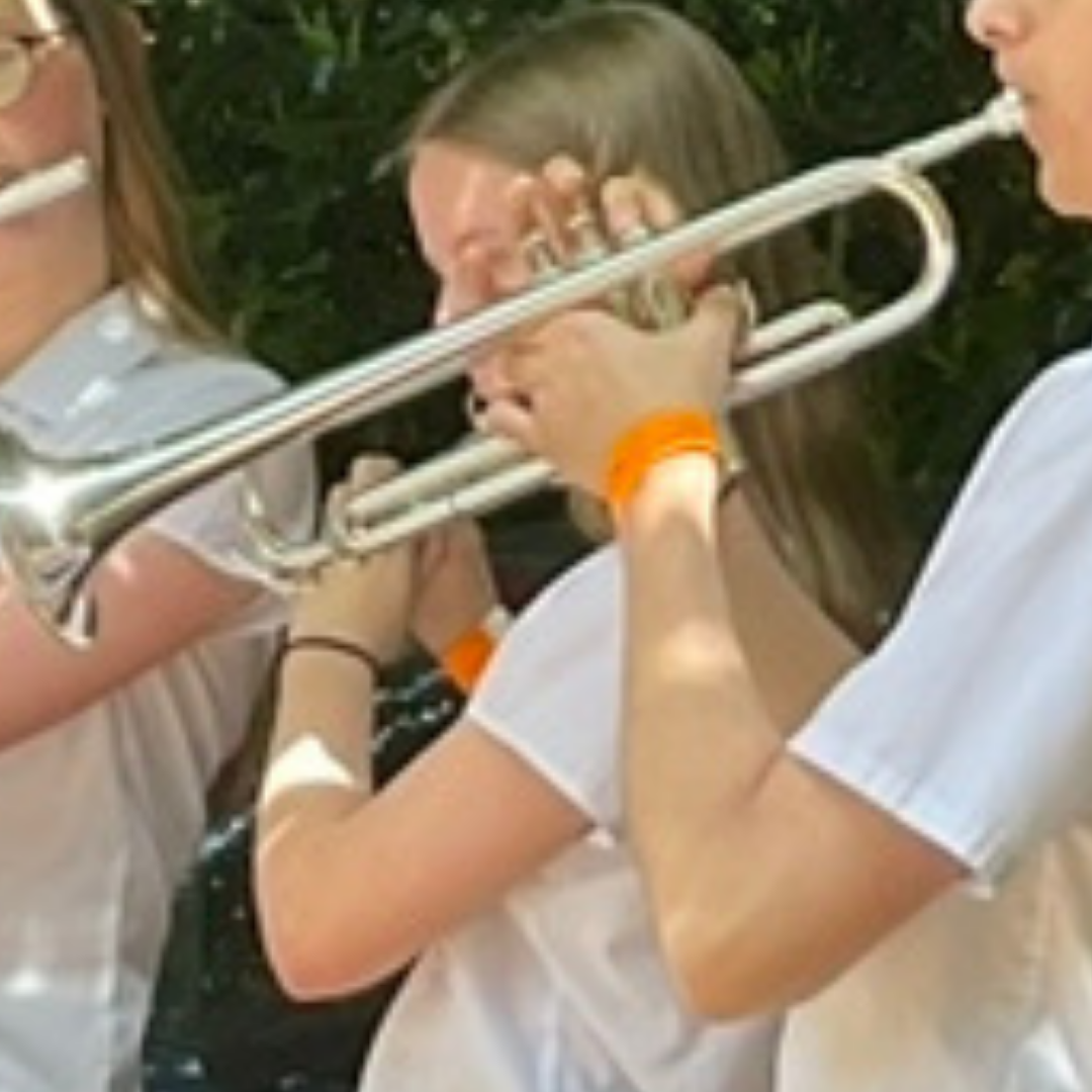 Close-up of pupils playing brass instruments during the jazz ensemble performance.