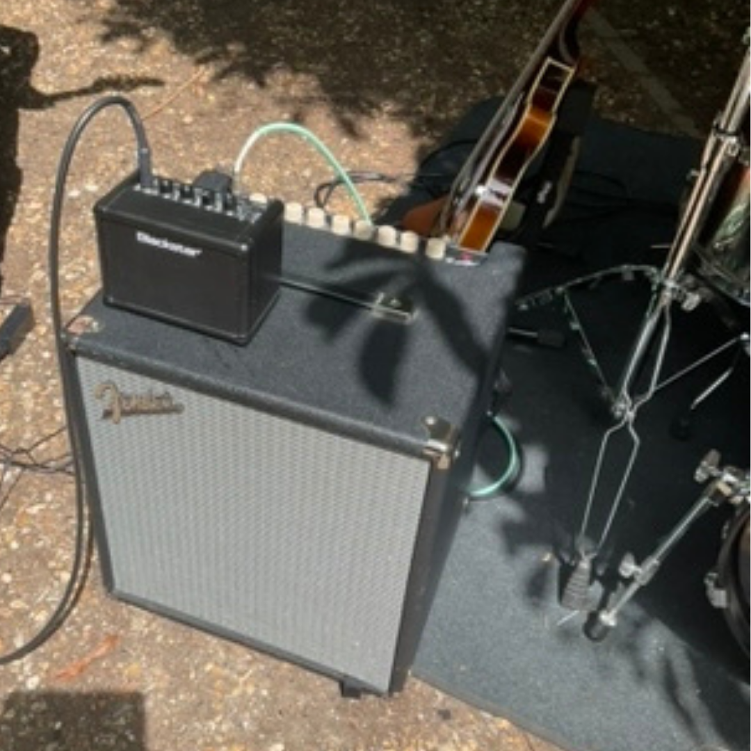 Guitar amplifier and music equipment set up for the jazz ensemble's outdoor performance.