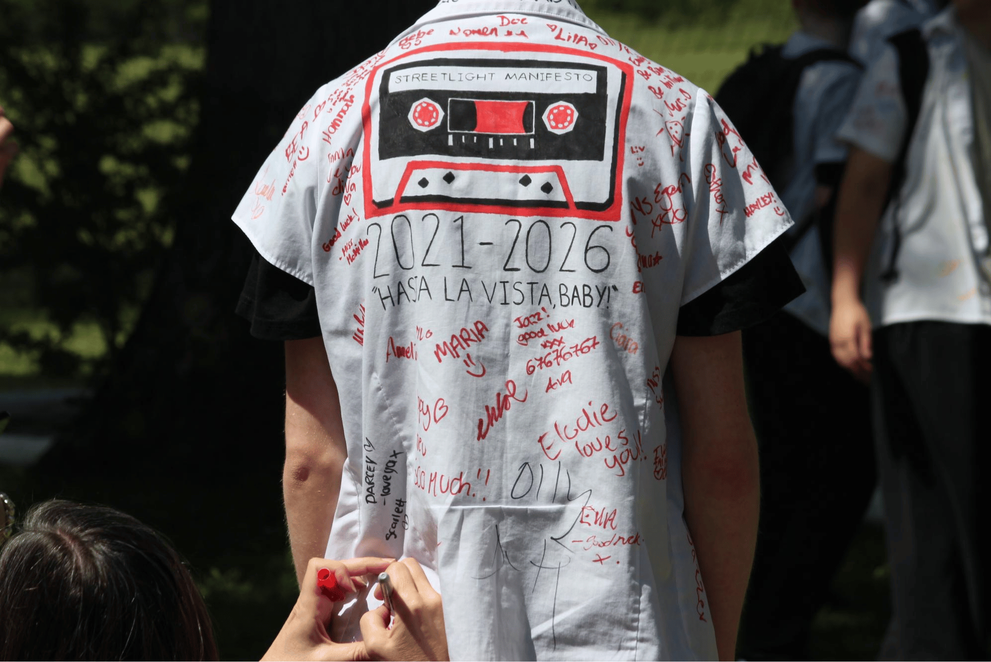 Year 11 pupil's shirt decorated with a cassette tape illustration, signatures and the years 2021–2026.