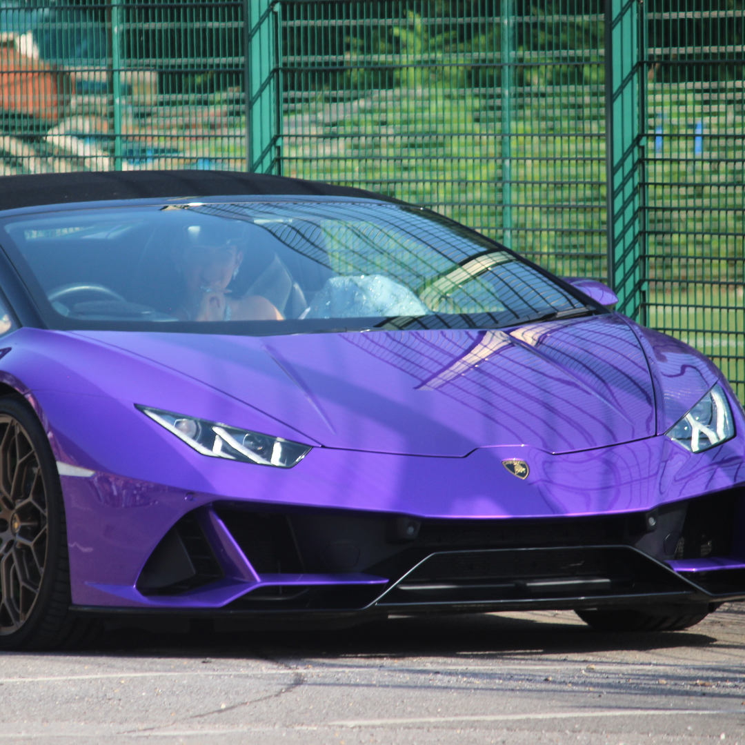 Purple Lamborghini arriving at the prom venue.