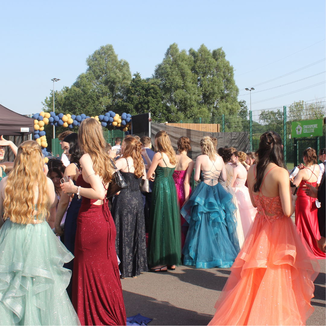 Group of pupils in formal attire gathered outdoors at the prom venue.