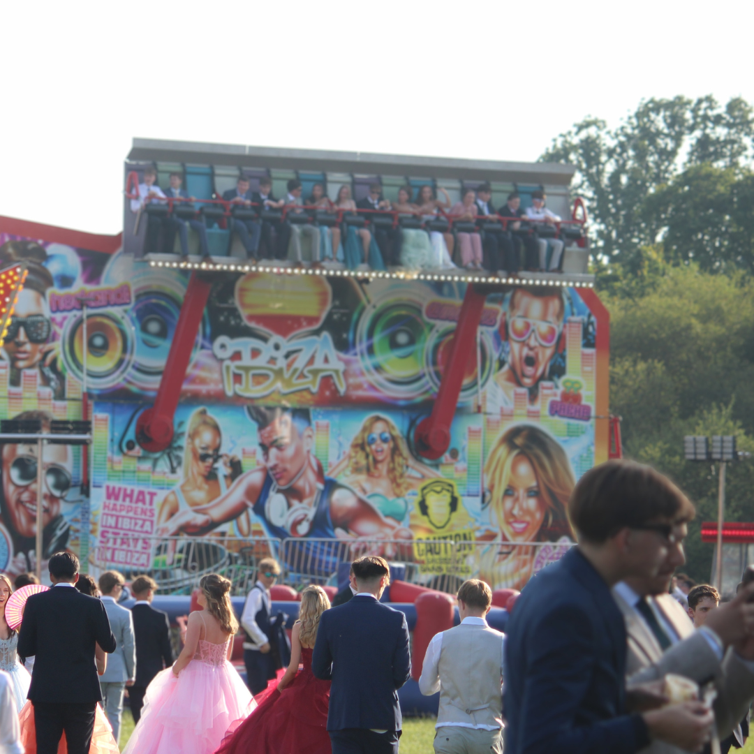 Pupils walking towards a fairground ride during the prom celebration.