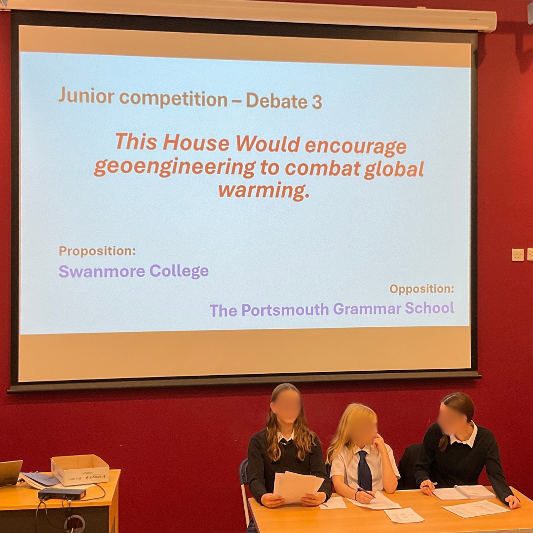 A photo of students competing in "Junior competition – Debate 3" on the motion "This House Would encourage geoengineering to combat global warming." A photo of a debate round during the "Junior competition – Debate 1" on the motion "This House Would ban cars from British city centres."