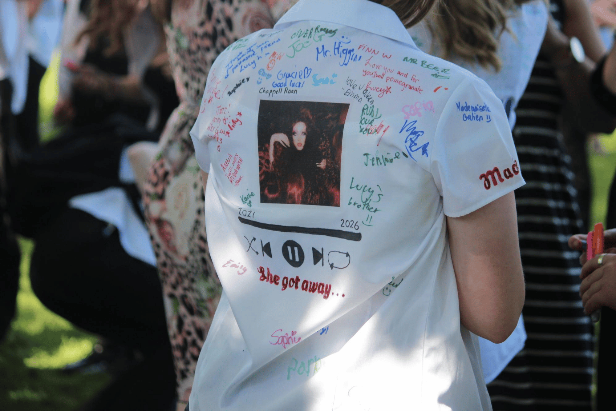 Year 11 pupil's shirt featuring a music-themed design, handwritten messages and signatures from friends.