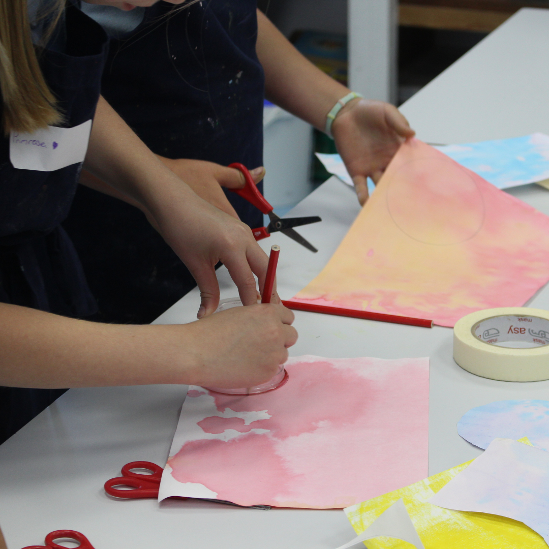 Image shows two pupils engaged in creating a piece of art