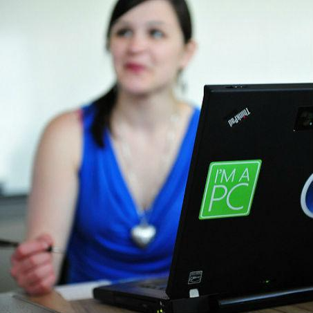Image shows an apprentice sitting behind a laptop