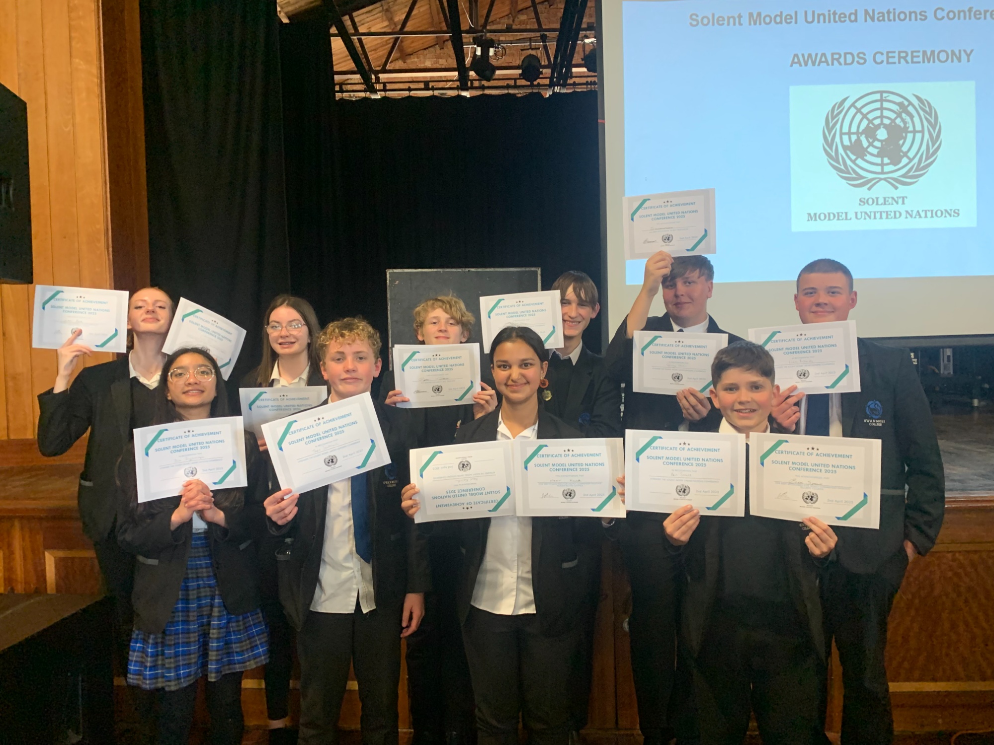 Image shows Swanmore College pupils who took part in the Solent Model United Nations Conference 2025 holding up their certificates of achievement