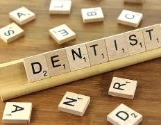 Image shows Scrabble tiles making up the word dentist