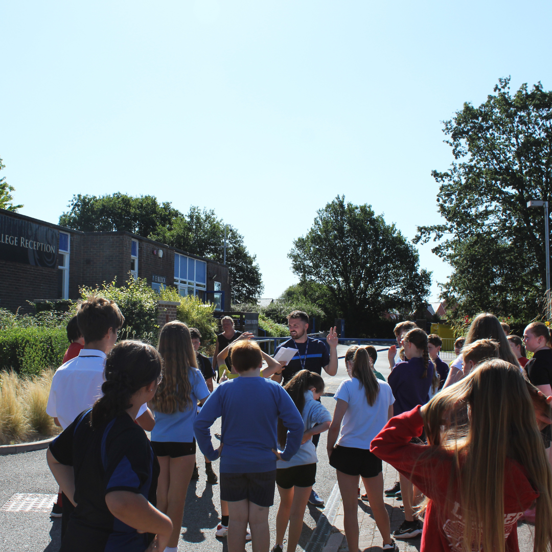Image shows pupils with their tutor learning about the school