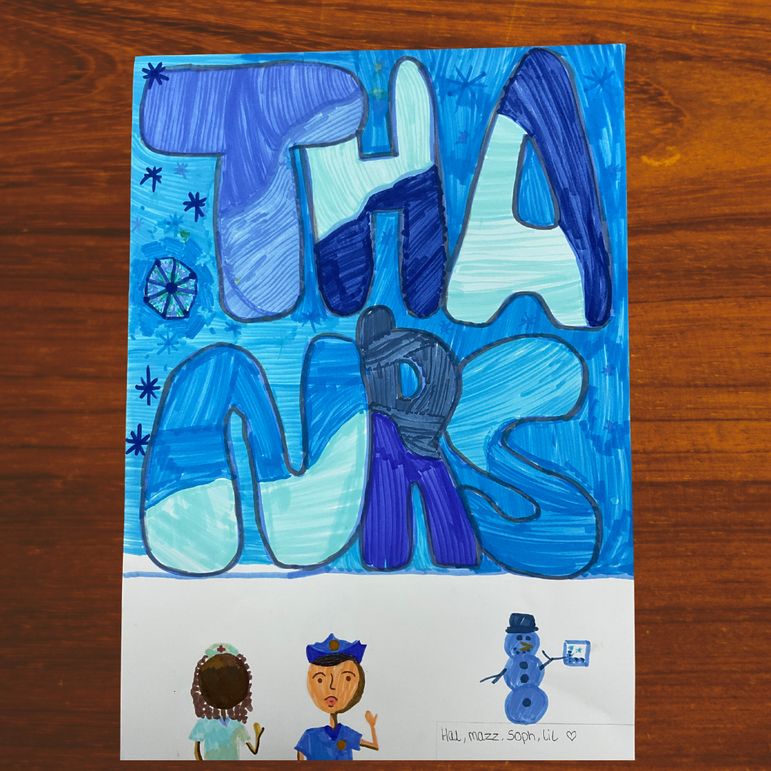 This image shows a hand-made poster featuring the word "Thanks" in large blue letters. At the bottom of the poster is an image of a nurse, a police officer and a snowman.