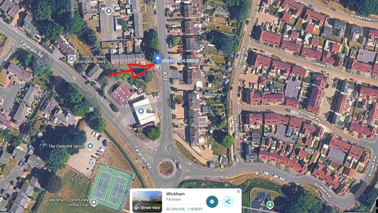 Satellite map view of Wickham showing the temporary school bus stop location for Wickham Horse Fair transport changes. A large red arrow points towards a marked location on the A32 near the junction with Fareham Road and close to the Shell garage roundabout.