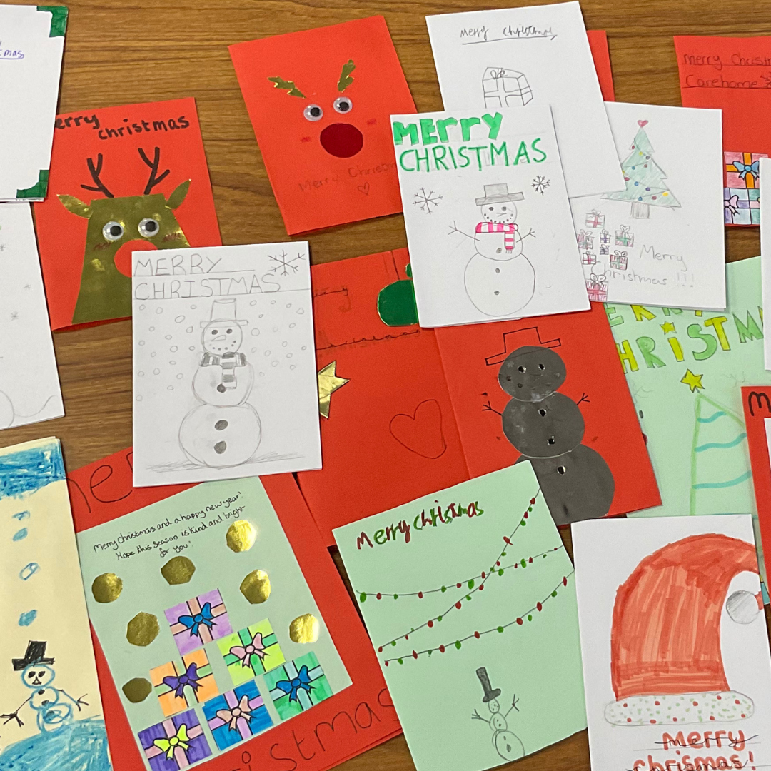 This image shows a variety of hand-made christmas cards on top of a table