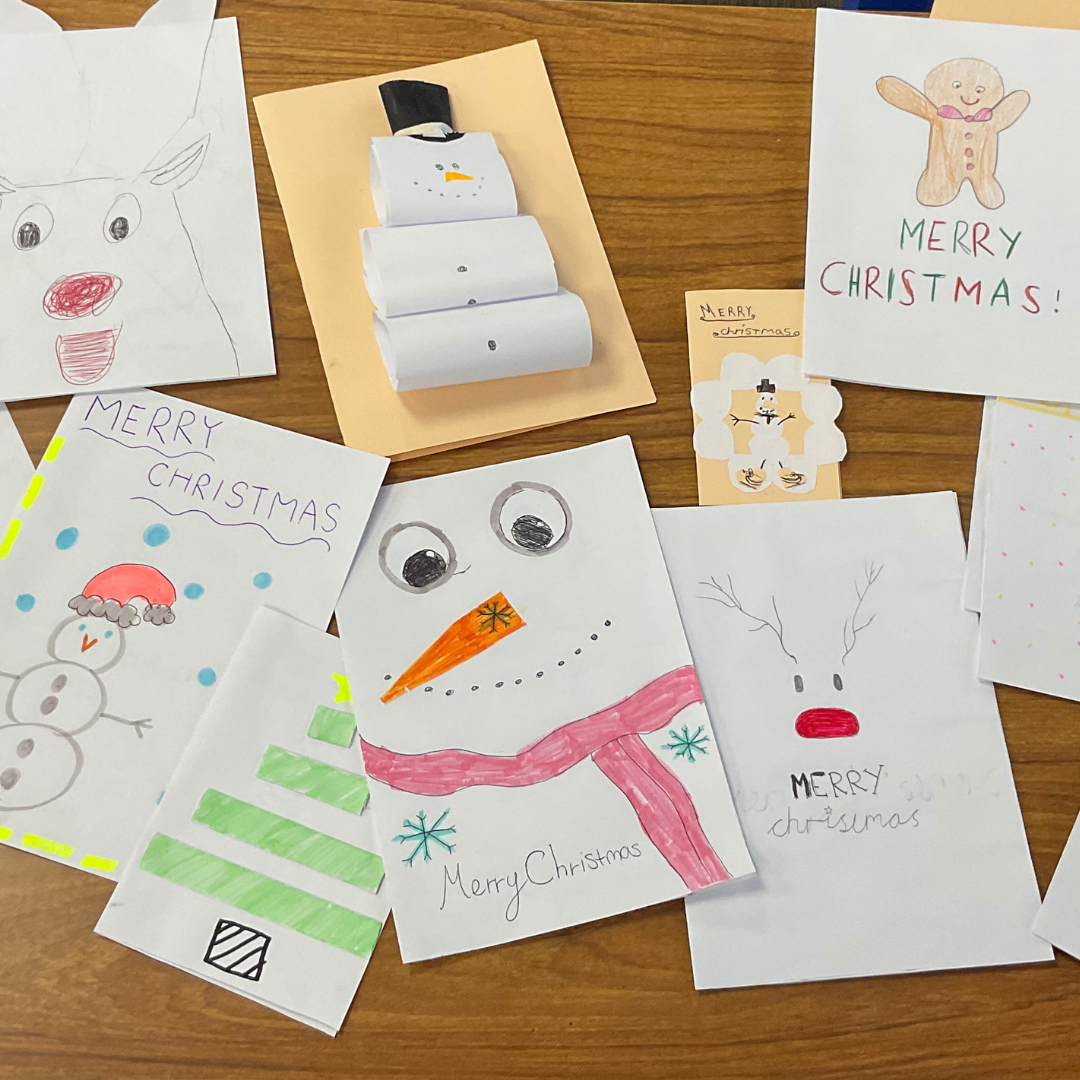 This image shows a variety of hand-made Christmas cards on a table