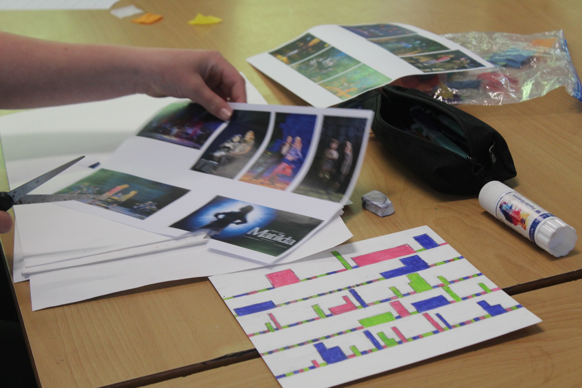Pupils taking part in Bronze Arts Award enrichment activities, using theatre photographs and creative resources to build project work inspired by Matilda the Musical.
