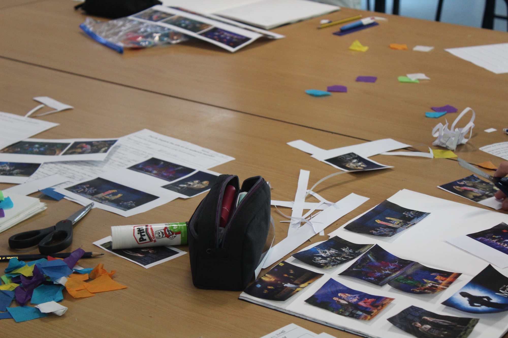 Bronze Arts Award pupils’ workspaces covered with theatre images, craft materials and scrapbook activities linked to Matilda the Musical.