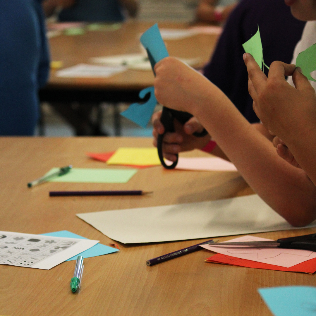Image shows pupils cutting up coloured paper