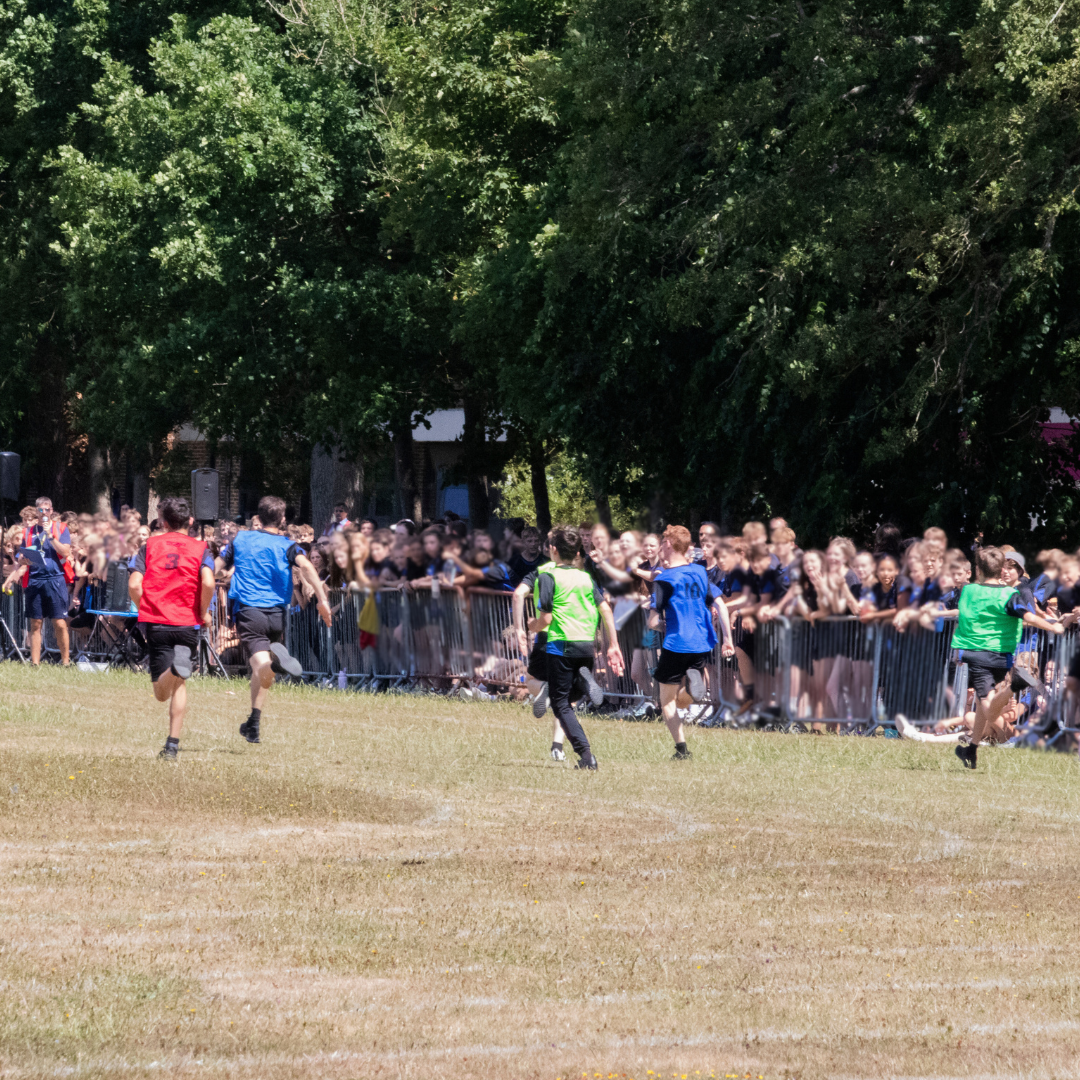 Image shows boys on the last straight of their running race