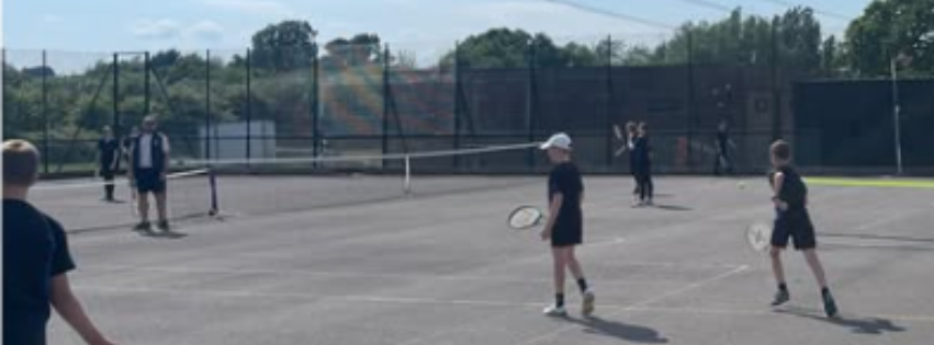 Image shows pupils playing tennis on the tennis courts during Tuesday afternoon's after school tennis club for years 7, 8 and 9.
