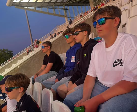 Image shows pupils watching the cricket at the T20 competition