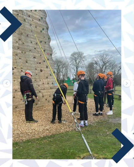 Image shows a group of pupils at the bottom of a different wall on the climbing tower