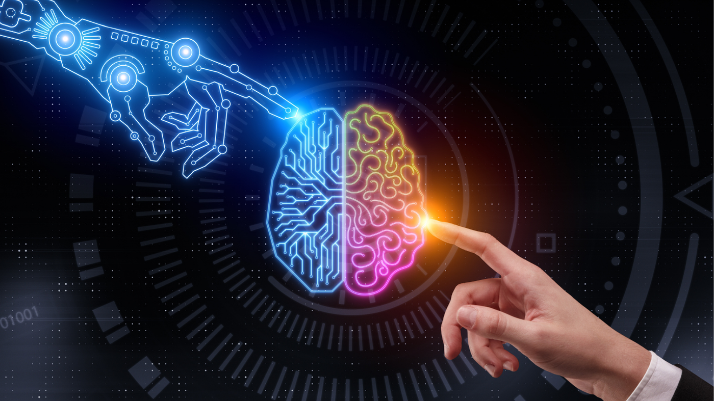 Image shows a brain made of light with 2 hands touching it with their index fingers - one is a human hand, the other is a hand also made of light