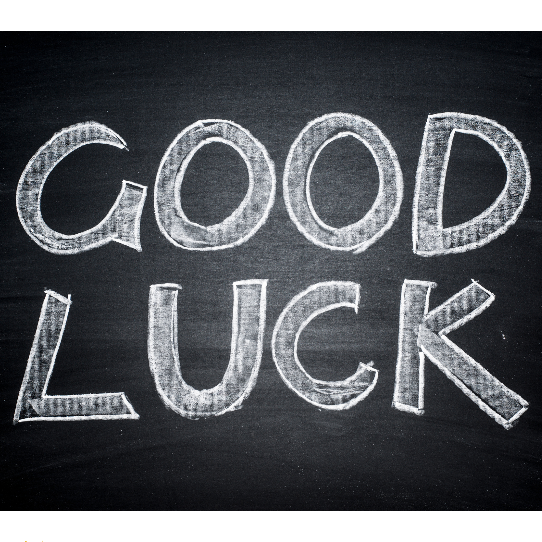 Chalkboard-style graphic displaying the words “GOOD LUCK” written in large white chalk lettering on a black background.