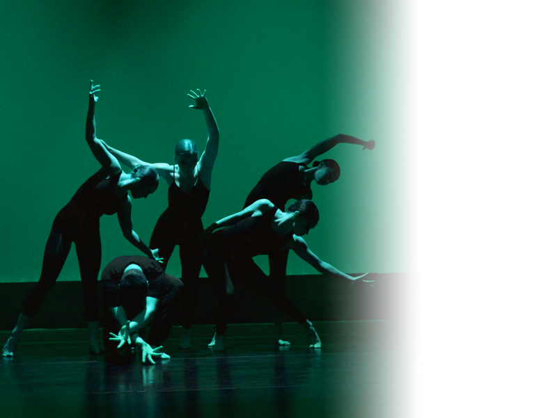 Image shows a group of 5 dancers in black leotards performing against a green background and lit with a green light