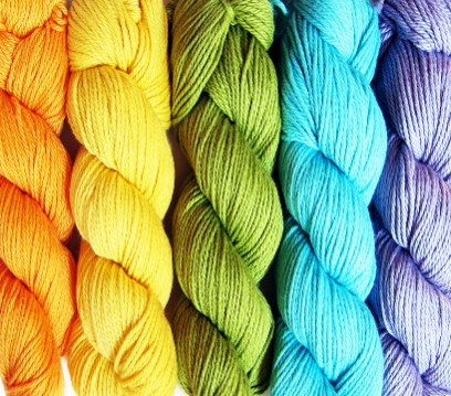 Image shows skeins of embroidery thread in orange, yellow, green, blue and purple