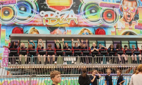 Image shows pupils on the magic carpet fair ground ride.