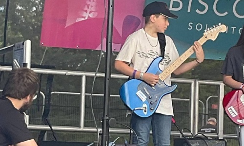 Image shows Swanmore College pupils performing on stage with their band at SwanFest 2024