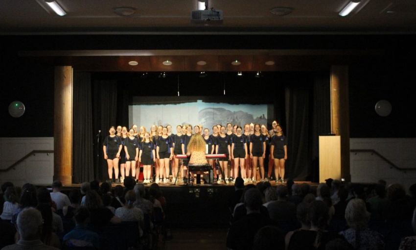 A choir performing on the main stage at Swanmore College